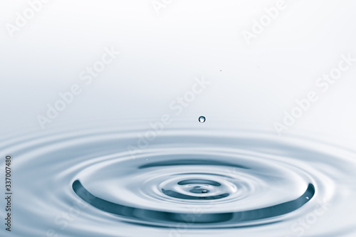 Waves on the surface of the water from a collision. Drop of water drop to the surface.