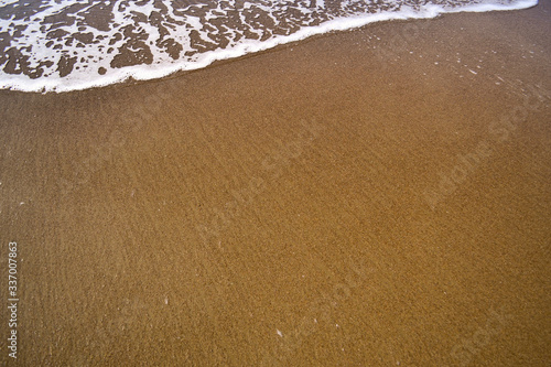 sandy beach and waves on a Sunny summer day. Copy space.