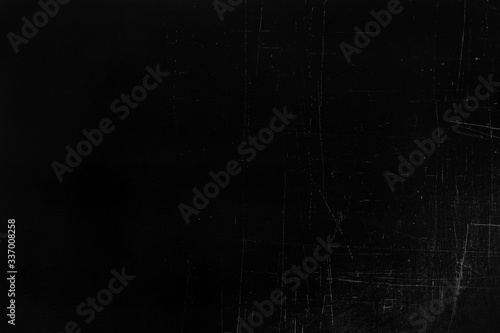 Old black stucco wall with white scratches and scuffs texture. texture grunge black board with chalk and cracks