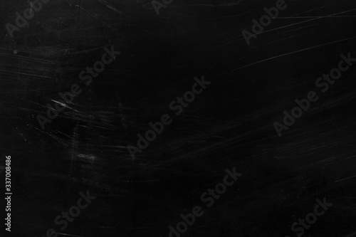 Old black stucco wall with white scratches and scuffs texture. texture grunge black board with chalk and cracks