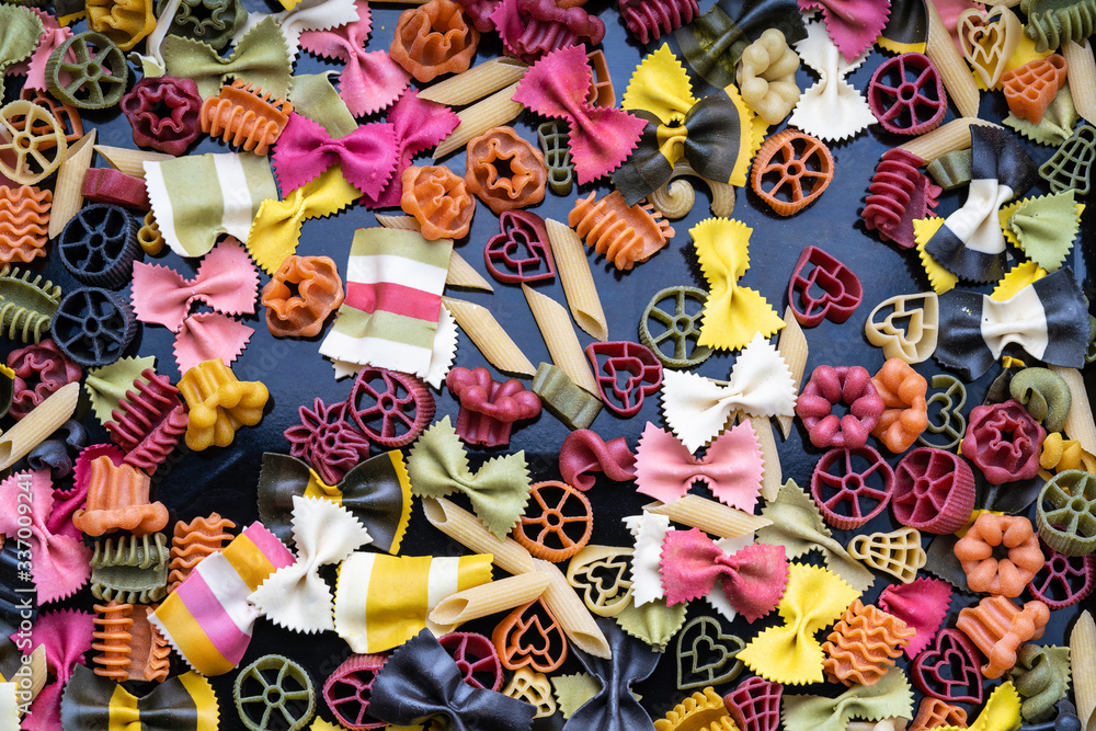 Cheerful colorful italian pasta. Different types of Italian pasta lying on top of each other