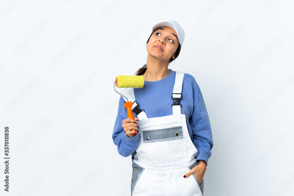 Painter woman over isolated white background and looking up Painter woman over isolated white background and looking up