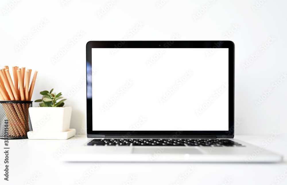 blank screen Modern laptop computer with mouse,Smart phone and Succulent on wood table in office view backgrounds blank screen Modern laptop computer with mouse,Smart phone and Succulent on wood table in office view backgrounds
