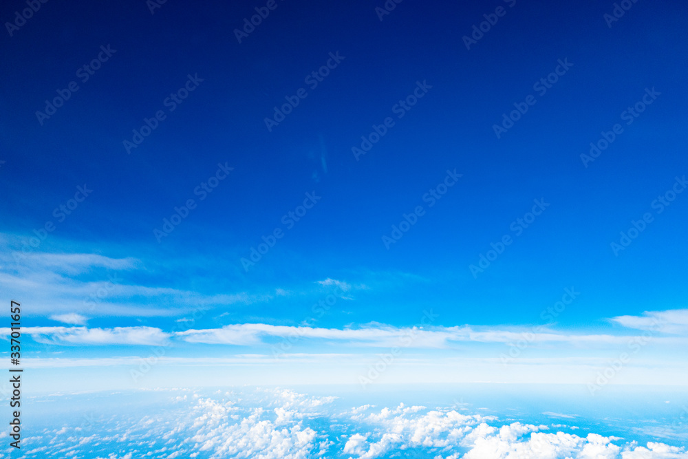 Beautiful clouds top view on a background of blue sky from the porthole of an airplane at altitude. Beautiful clouds top view on a background of blue sky from the porthole of an airplane at altitude.
