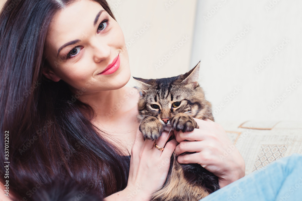 © artem_goncharov - Home cat is not happy with hugs with the Proprietress