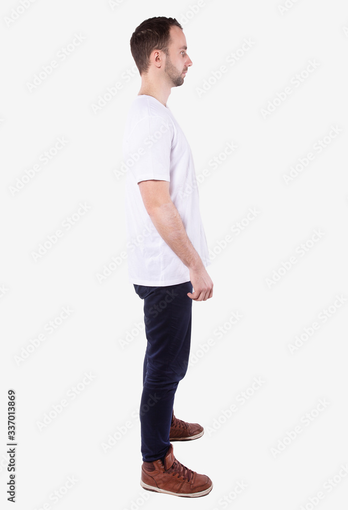 Full length man in casual wear stands sideways, looks ahead. White background Full length man in casual wear stands sideways, looks ahead. White background