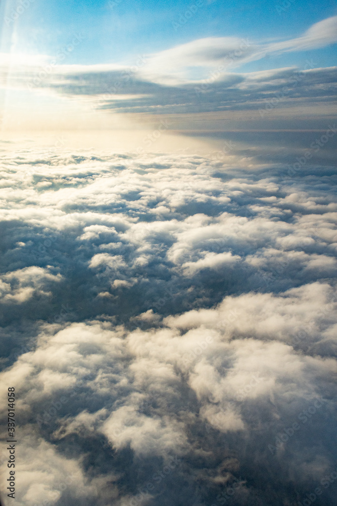 Clouds from above from an airplane on a sunny day.