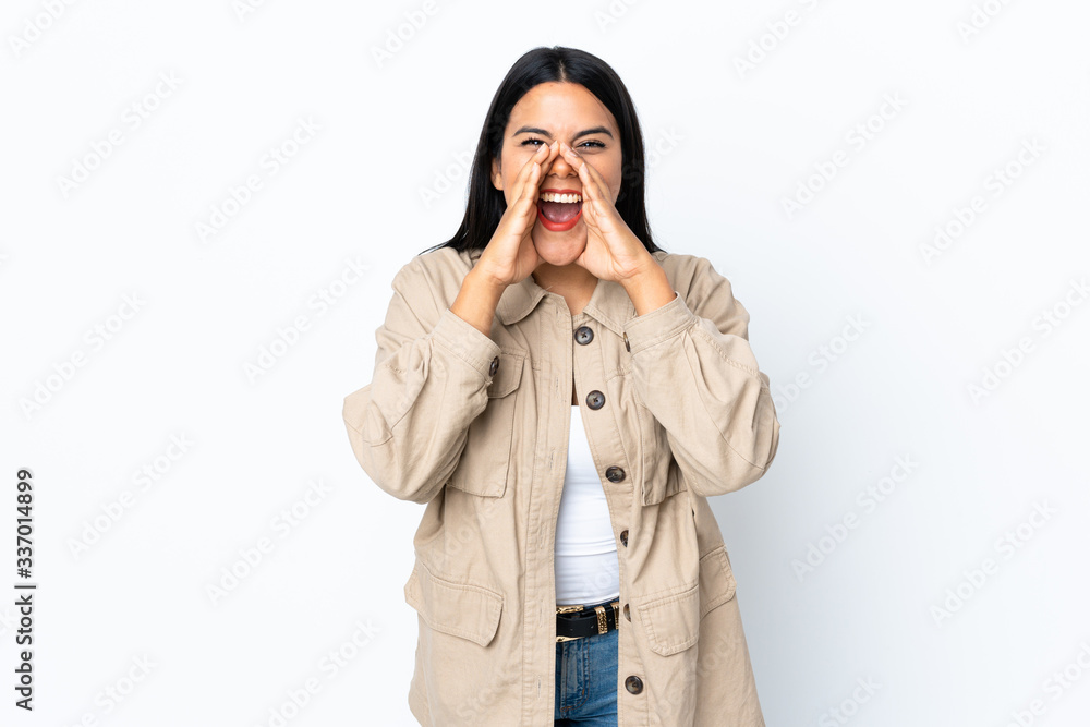 Young latin woman woman isolated on white background shouting and announcing something Young latin woman woman isolated on white background shouting and announcing something