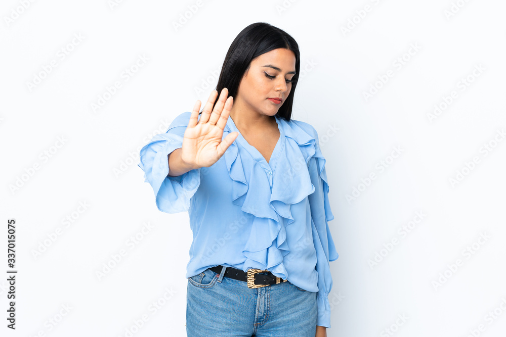 Young latin woman woman isolated on white background making stop gesture and disappointed Young latin woman woman isolated on white background making stop gesture and disappointed
