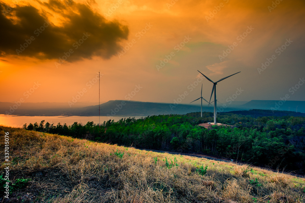 Obraz premium Natural blurred natural background, high angle viewpoint area, overlooking trees and mountains and large windmills,abundance of forests
