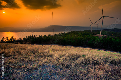 Natural blurred natural background, high angle viewpoint area, overlooking trees and mountains and large windmills,abundance of forests
