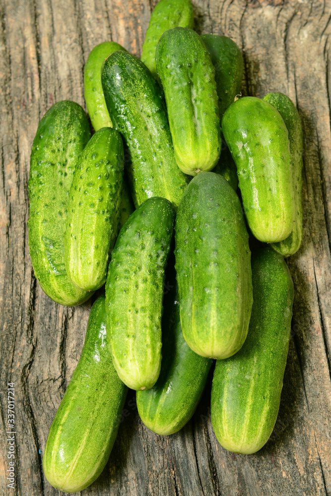 Fresh cucumbers on a wooden table close-up. Fresh cucumbers on a wooden table close-up.