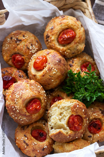 Muffins with cheese, cottage cheese and tomatoes, vegetables and cheese served with wine.