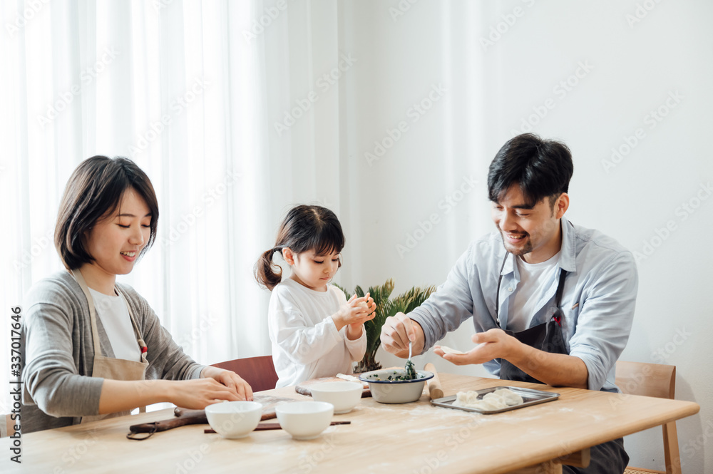 Mom and Dad and daughter at home dumplings Mom and Dad and daughter at home dumplings