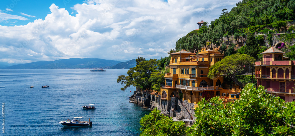 Fototapeta premium Scenic picture-postcard view of famous with wonderful gulf, luxury villas in mediterranean garden, rock and boats, yachts in spectacular vacation resort, Portofino, Liguria, Italy, Europe.