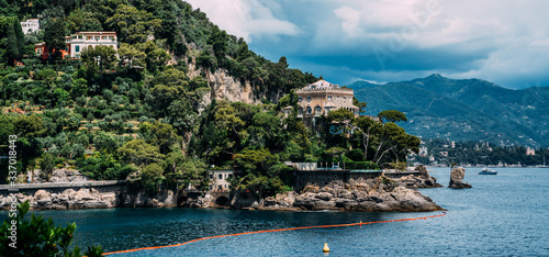 Fototapeta Naklejka Na Ścianę i Meble -  Scenic picture-postcard view of famous with wonderful gulf, luxury villas in mediterranean garden, rock and boats, yachts in spectacular vacation resort, Portofino, Liguria, Italy, Europe.