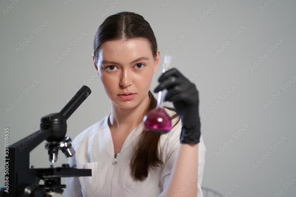 portrait of a girl doctor with a microscope portrait of a girl doctor with a microscope