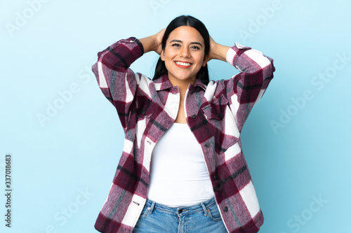 Young latin woman woman isolated on blue background laughing