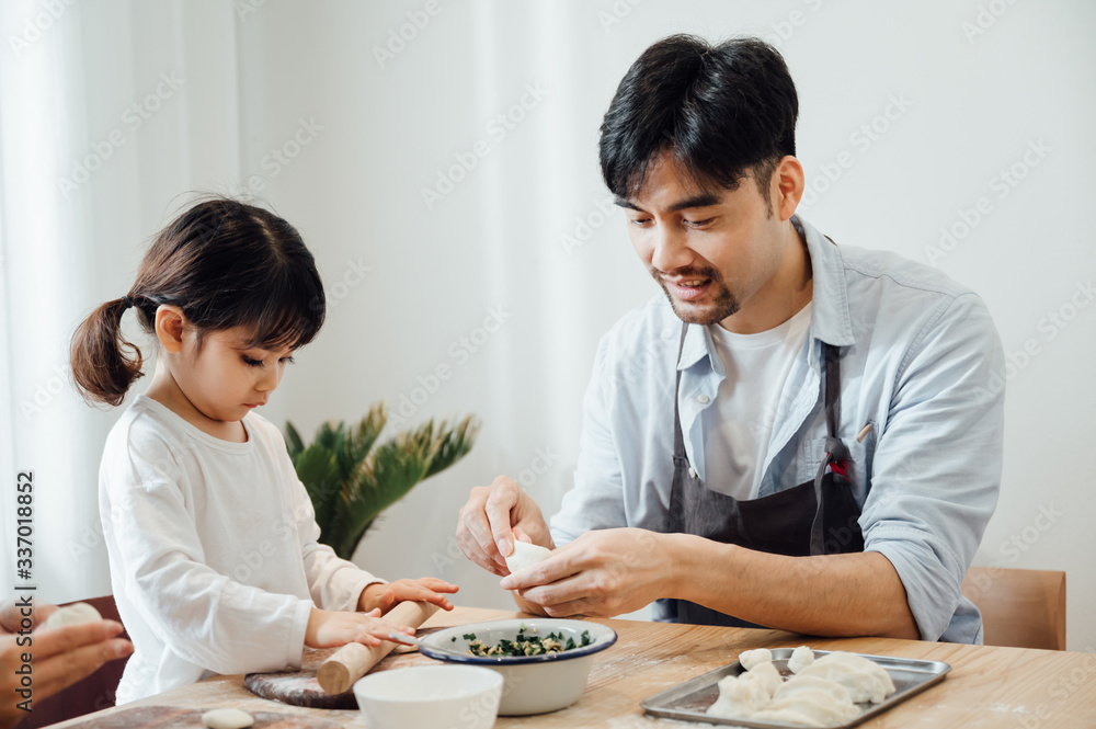 Mom and Dad and daughter at home dumplings Mom and Dad and daughter at home dumplings
