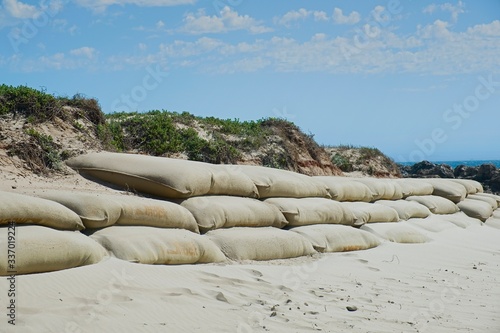 large burlap or hessian sandbags stopping soil erosion on a beach photo