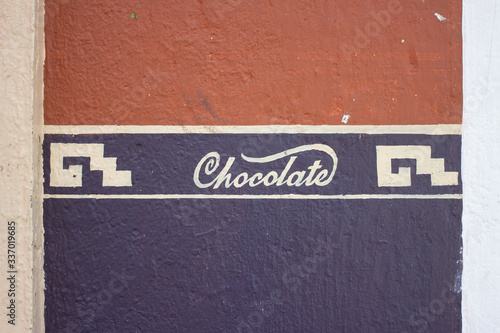 hand-painted chocolate sign on a wall