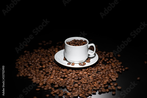 Cup with coffee beans on a dark background