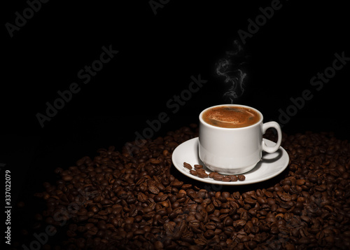 Cup with coffee beans on a dark background