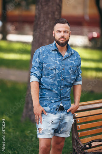 Young guy walking in the spring park. Sunny day. Vesna.Funny guy. A good mood.