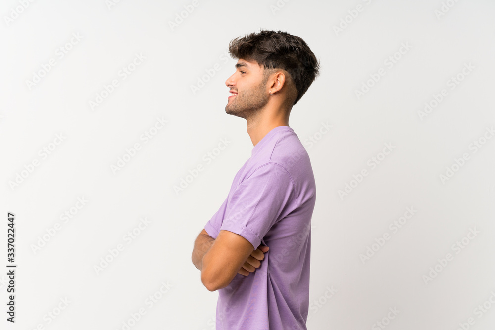 Young handsome man over isolated white background in lateral position Young handsome man over isolated white background in lateral position