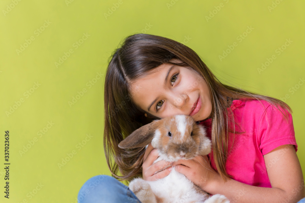 Little girl playing with her pet rabbit Little girl playing with her pet rabbit
