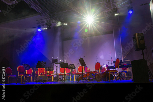 Musical instruments of symphonic orchestra and music stands for music on the concert stage