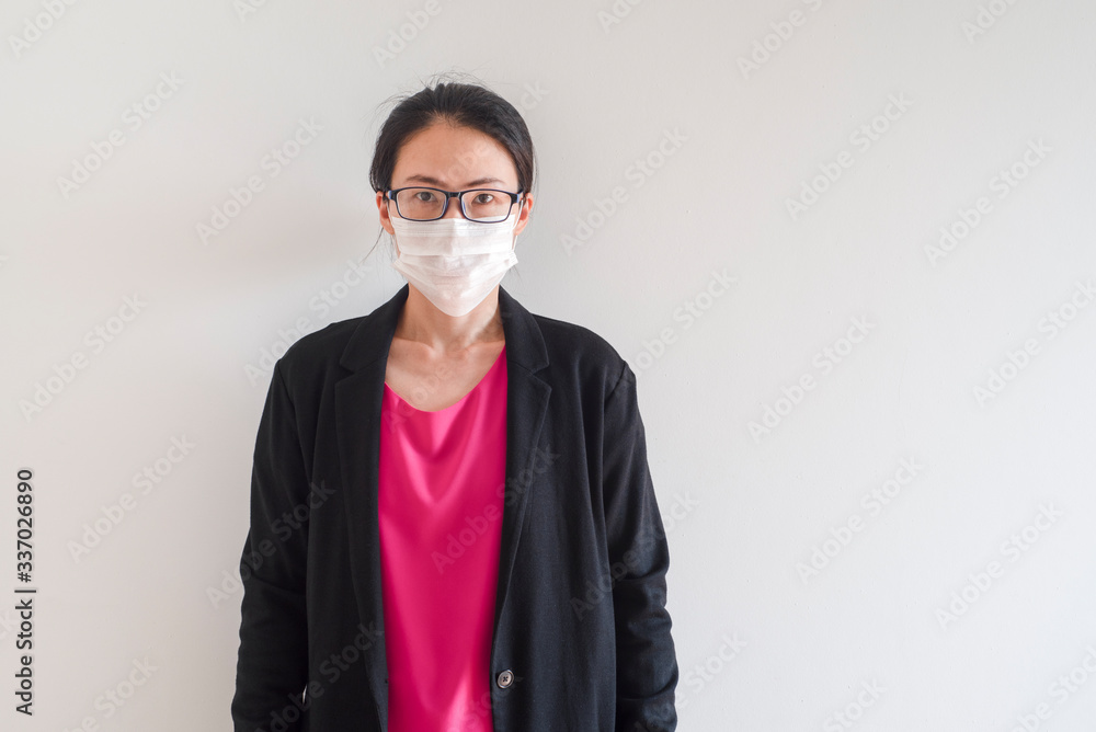 Female Asian young woman wearing surgical mask feeling sick headache and coughing leaning on wall isolated on white background.Wuhan coronavirus (COVID-19) outbreak prevention. Health care concept Female Asian young woman wearing surgical mask feeling sick headache and coughing leaning on wall isolated on white background.Wuhan coronavirus (COVID-19) outbreak prevention. Health care concept