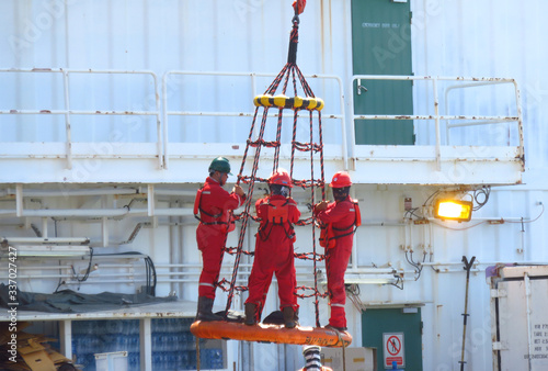 Foto Songkhla, Thailand-February 12, 2020 : Workers are lifted by the crane to the of