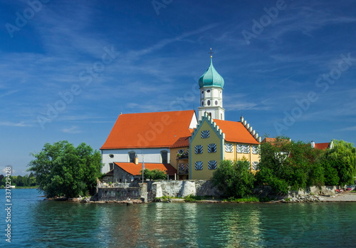 View from the lake of the castle and the bell tower of St. George. Wasserburg Bodensee Soft focus, blurry background.