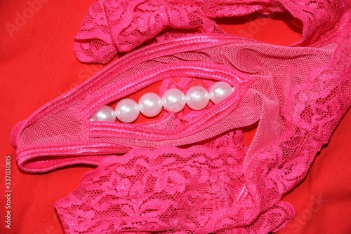 Close up of a pink woman panties decorated by pearls