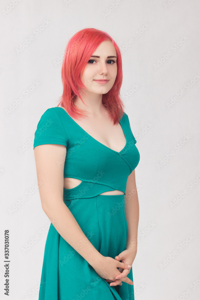 Portrait of a young woman with red hair and green dress with blue eyes Portrait of a young woman with red hair and green dress with blue eyes