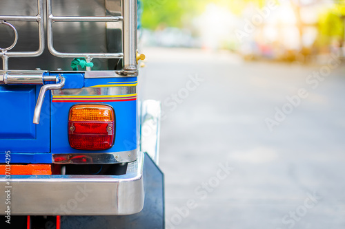 Background of colorful blue yellow tuk tuk traditional local taxi car for tourist with copy space. City lockdown coronavirus quarantine social distancing tourism empty in bangkok no traveler passenger