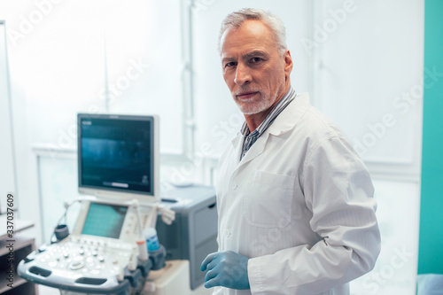 Confident doctor in modern clinic with good equipment stock photo