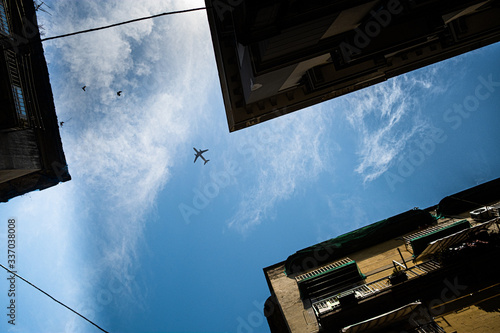 Look at the sky on a flying plane from the street of Naples.
