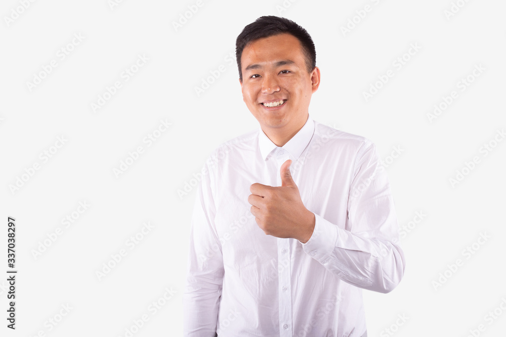 Attractive asian man with broadly smile holding hand with thumb up in like sign Attractive asian man with broadly smile holding hand with thumb up in like sign