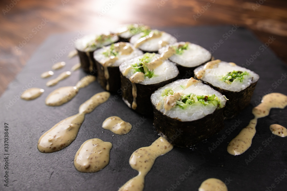 chuka rolls with sauce on black japan plate close up chuka rolls with sauce on black japan plate close up