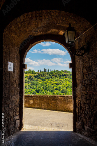 Via Borghese or Borghese Street arch with scenic view in the historic district of Bomarzo, Province of Viterbo, Lazio, Italy