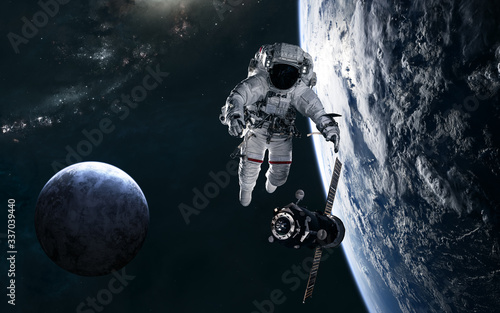 Fototapeta Naklejka Na Ścianę i Meble -  Astronaut, space station, planets in deep space against backdrop of spiral galaxy. Science fiction. Elements of this image furnished by NASA