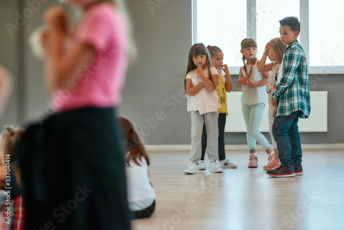 Dance training. Group of children studying standing in the dance studio. Choreography class