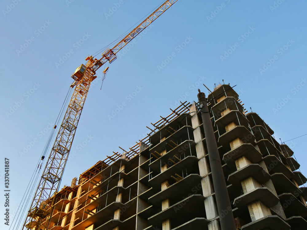 Construction site. Building site with crane. Concrete building under construction Construction site. Building site with crane. Concrete building under construction