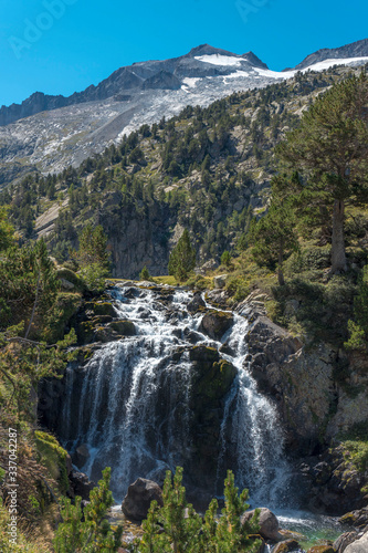 view of the aneto and waterfall in the pyrenees