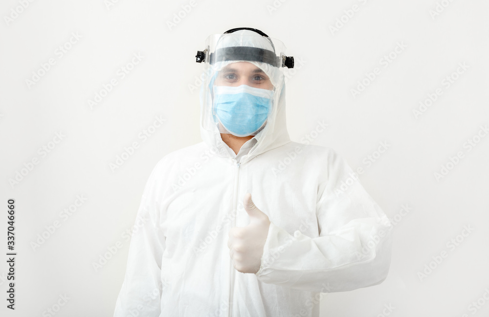 Disinfector or Doctor wearing protection suit and face mask showing thumbs up,positive gesture. Like to the end of pandemic epidemic Covid-19, Coronavirus, Quarantine. Concept of medicine health care Disinfector or Doctor wearing protection suit and face mask showing thumbs up,positive gesture. Like to the end of pandemic epidemic Covid-19, Coronavirus, Quarantine. Concept of medicine health care
