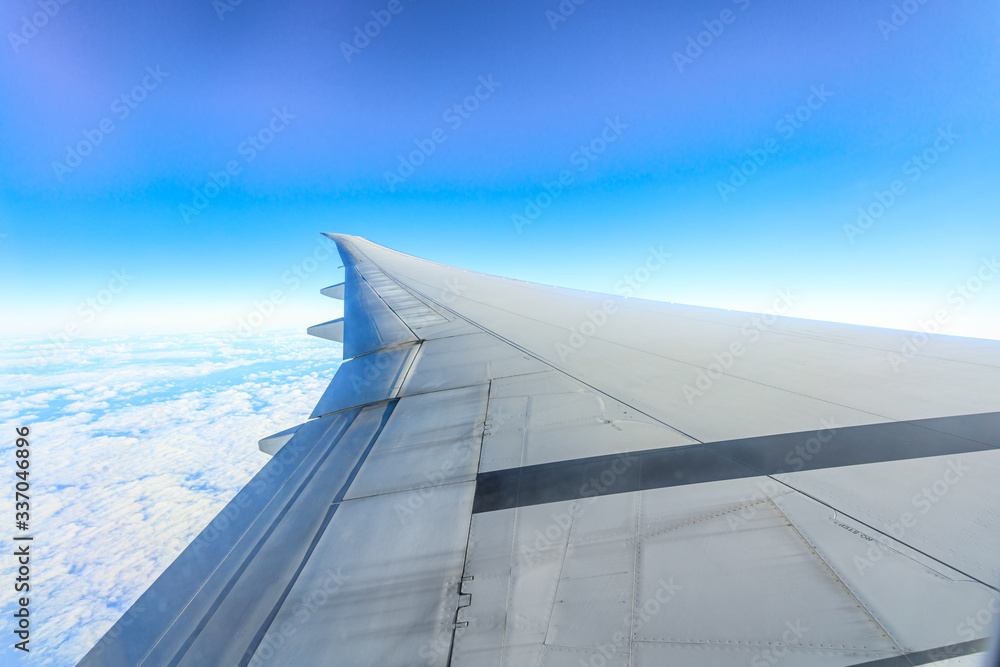 Fototapeta premium View from airplane wing through hublot in the air