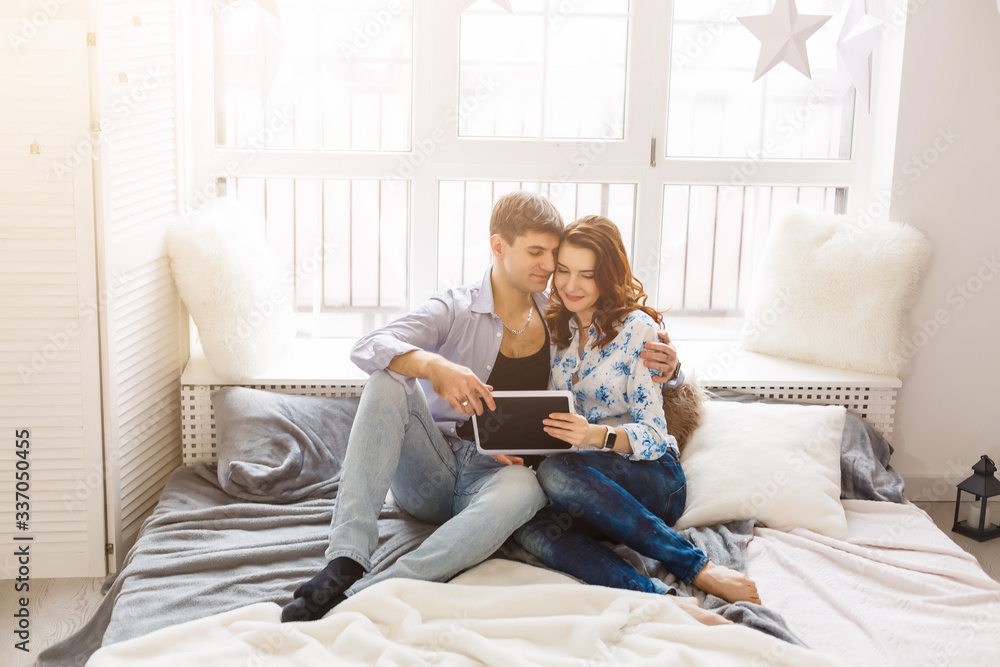 Happy young couple doing shopping on internet Happy young couple doing shopping on internet