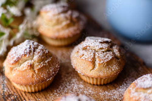 Fresh baked cupcakes of rice flour with banana and vanilla with a mug of hot chocolate